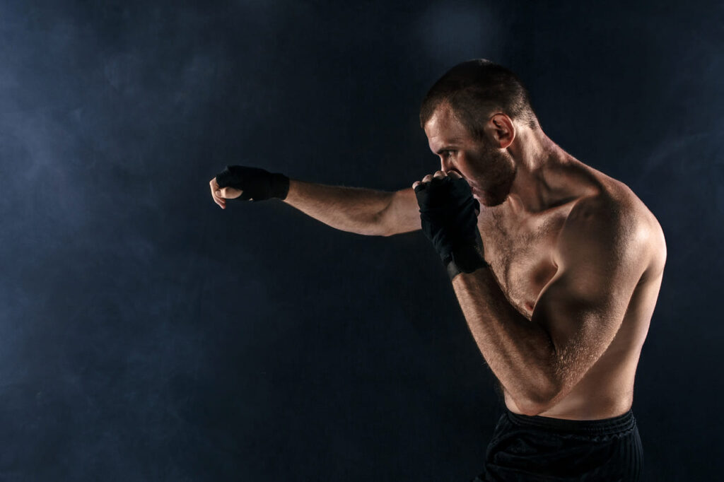 the-young-man-kickboxing-on-black-copyspace